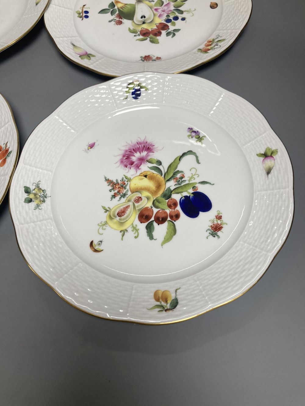 A set of four Herend Meissen style floral painted dessert dishes, diameter 25.5cm